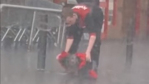 Illustration : La direction d'un magasin récompense la bonté d'un employé sorti couvrir un chien, attaché sous la pluie