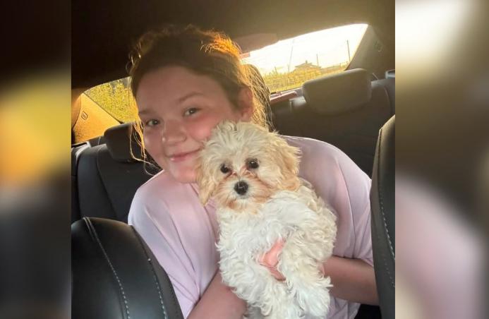 Ava sourit à l'arrière d'une voiture, Bonnie blottie contre elle
